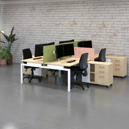 Office setting with balance back-to-back 4 person desk with white frame and refined oak top set up with chairs, caddy's, computer monitors and divider screens.