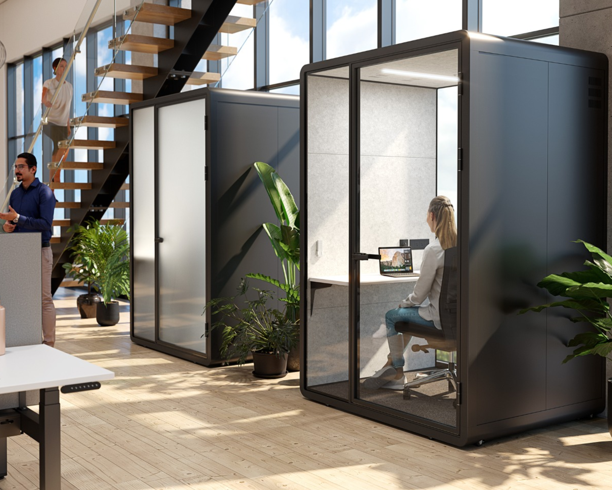 Modern office space with glass workstations and people working.